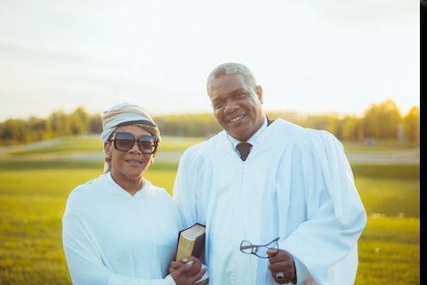 A male and female wedding minister standing next to each other and smiling. They represent the top quality of wedding officiants in Fredericksburg TX.