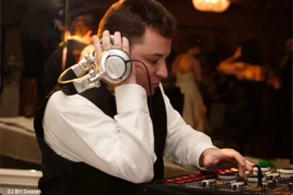 Closeup of a wedding DJ from Cutting Edge Entertainment playing music at a wedding in Fredericksburg TX