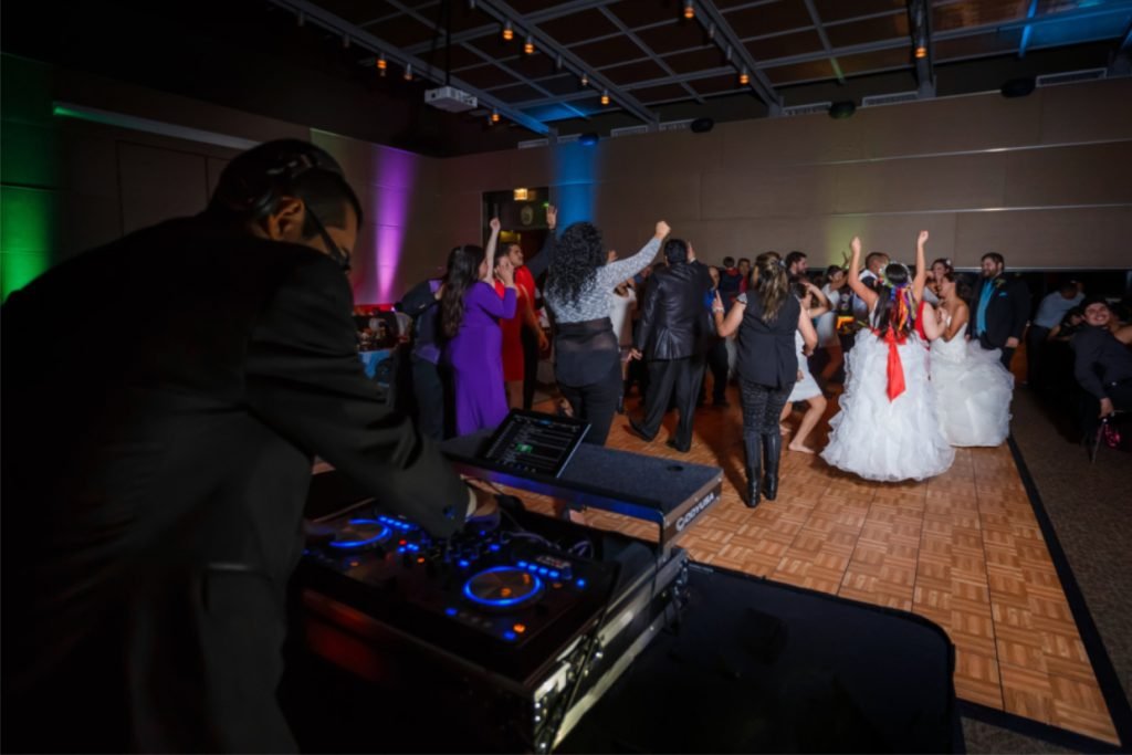 A wedding DJ from Cutting Edge Entertainment playing music at a wedding reception in Fredericksburg TX