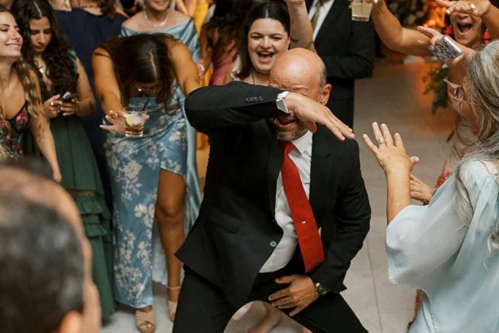 A male wedding guest dancing on a crowded dance floor, representing the fun Gaines Entertainment provides at weddings in Fredericksburg TX