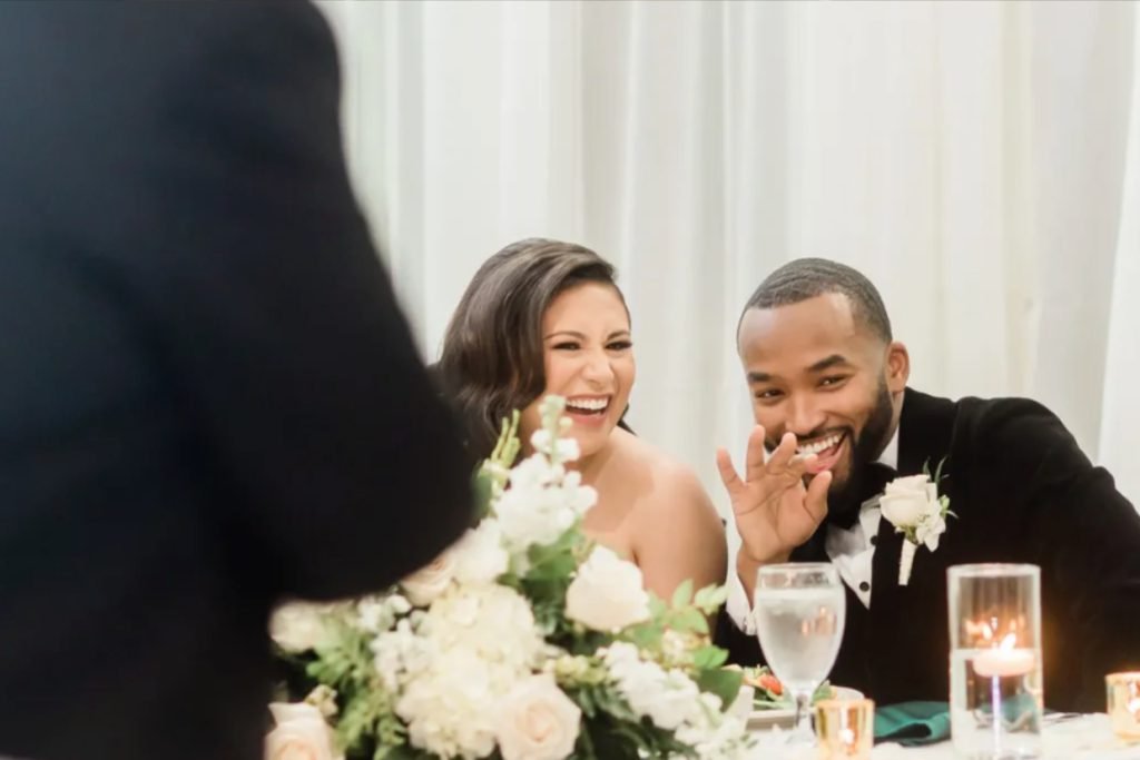 A bride and groom laughing during a toast, depicting the joy at weddings in Fredericksburg TX