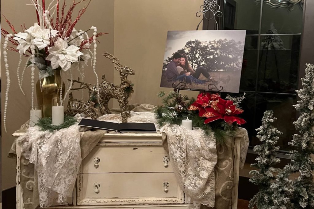 A white antique dresser with wedding decor, created by The Party Affair for one of their weddings in Fredericksburg TX