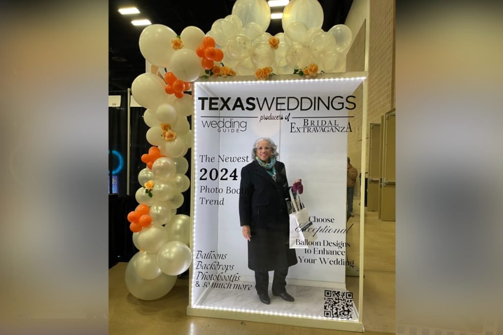 A unique wedding photo booth for Texas Weddings magazine with a white and orange balloon arch